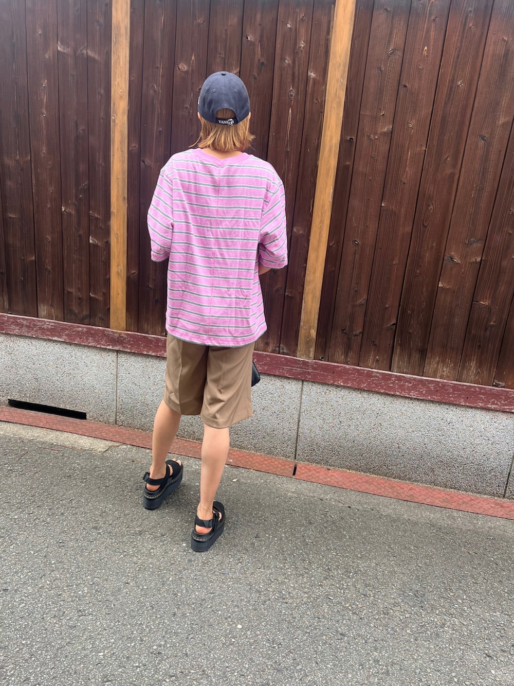 ピンク系のTシャツ/カットソー、ブラック系のサンダル、ブラウン系のその他パンツを着用したレディースの夏コーディネートの3枚目の写真