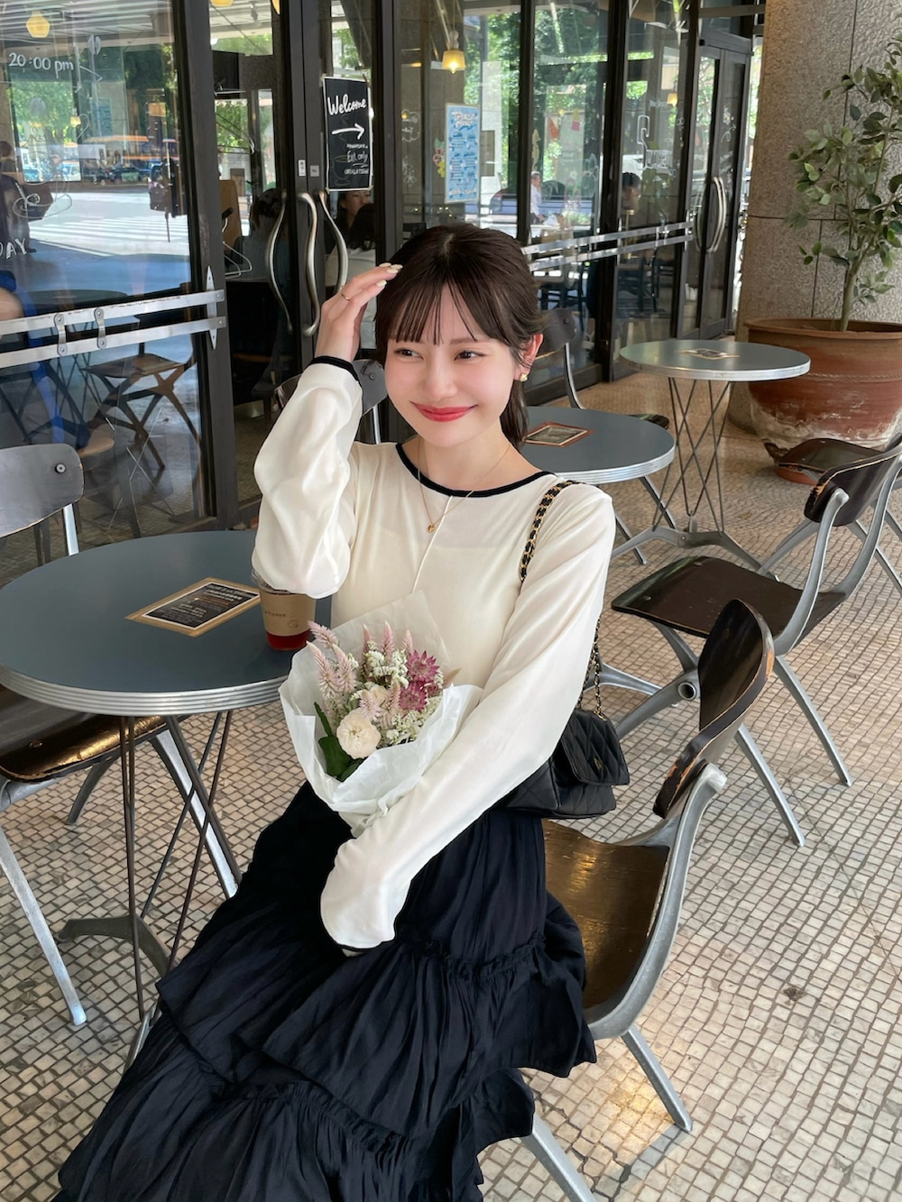 ブラック系のスカート、ホワイト系のTシャツ/カットソー、ホワイト系のTシャツ/カットソーを着用したレディースの秋コーディネートの4枚目の写真