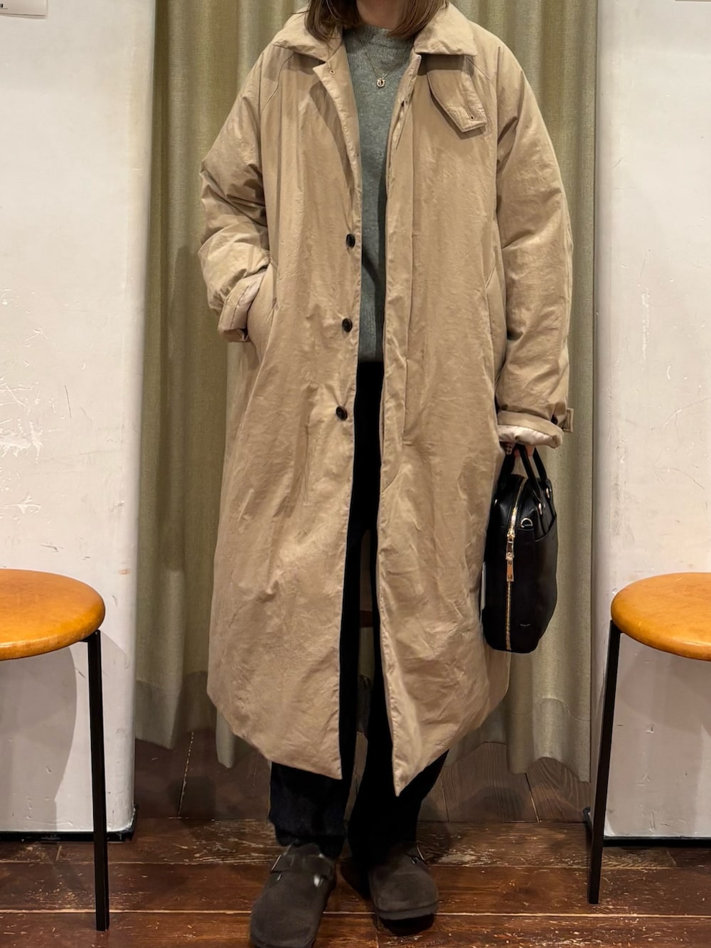 グリーン系のニット/セーター、ベージュ系のダウンジャケット/コート、ブラック系のその他パンツを着用したレディースの冬コーディネートの4枚目の写真