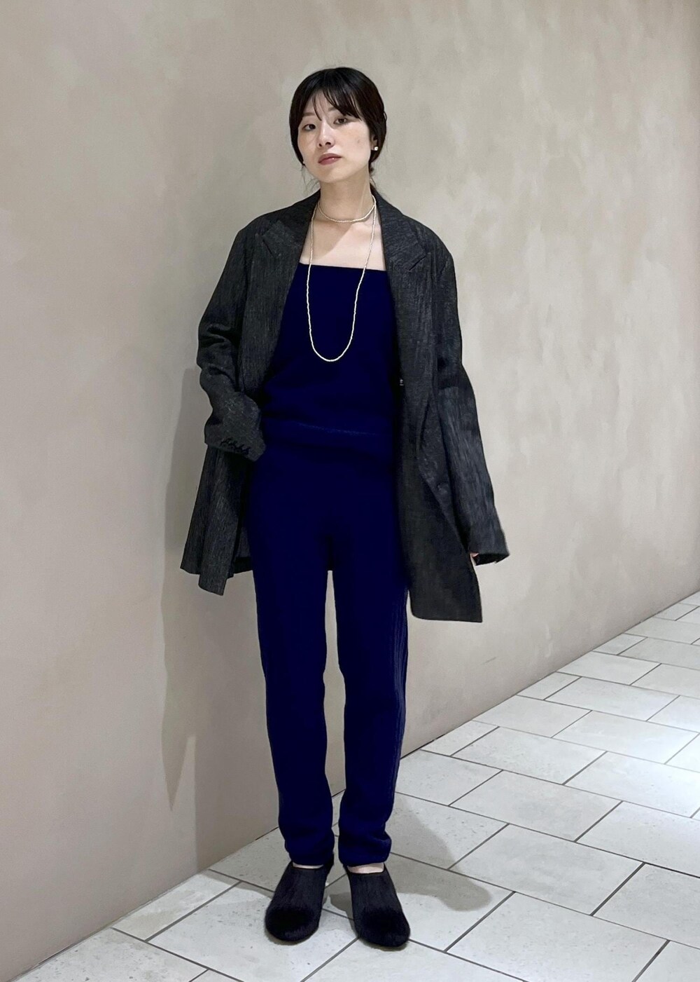 ブラック系のテーラードジャケット、ブラック系のハンドバッグ、ブラック系のその他シューズを着用したレディースの秋コーディネートの2枚目の写真