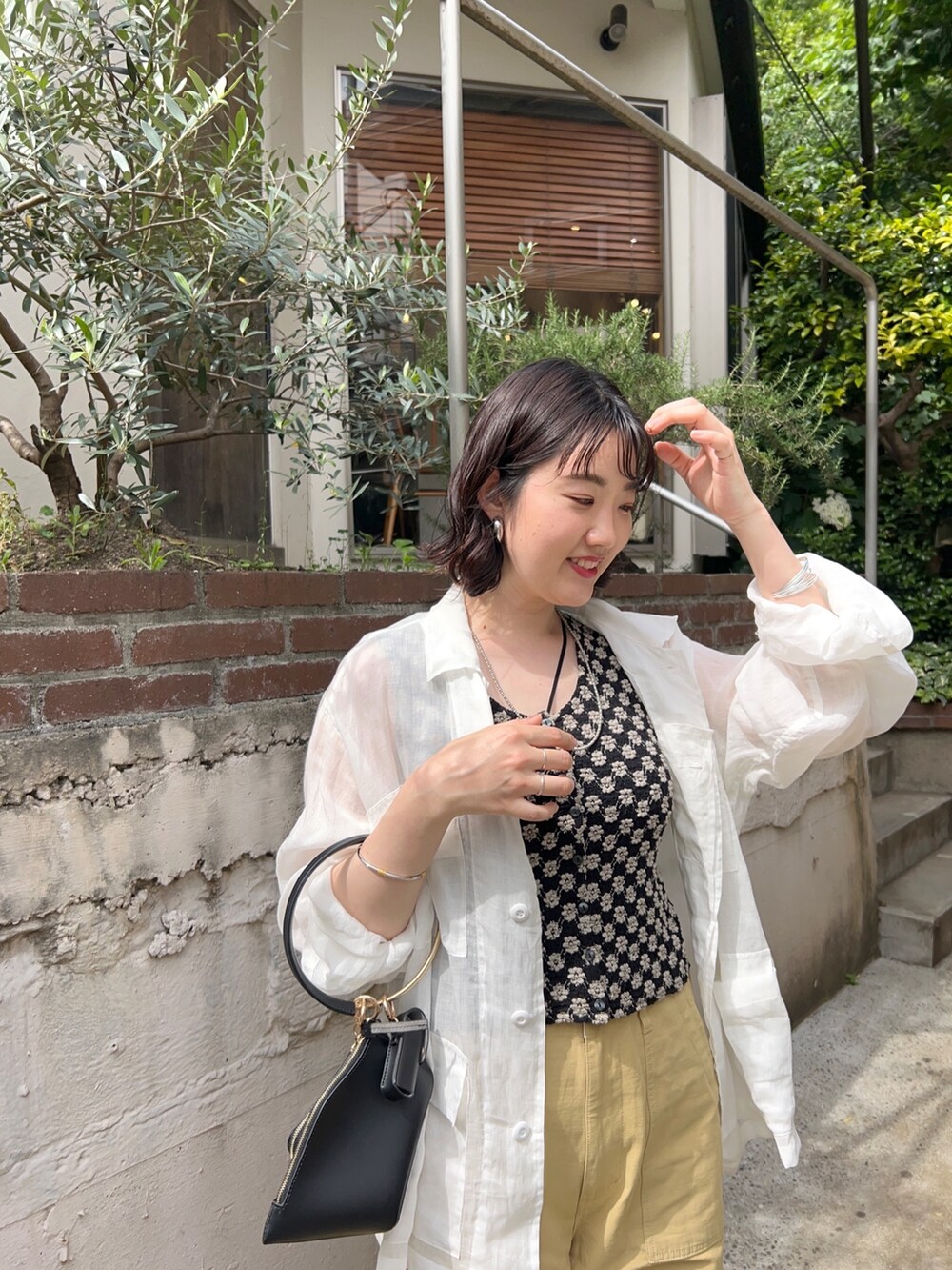 グリーン系のジャケット/アウター、ブラック系のTシャツ/カットソー、ベージュ系のパンツを着用したレディースの春コーディネートの3枚目の写真