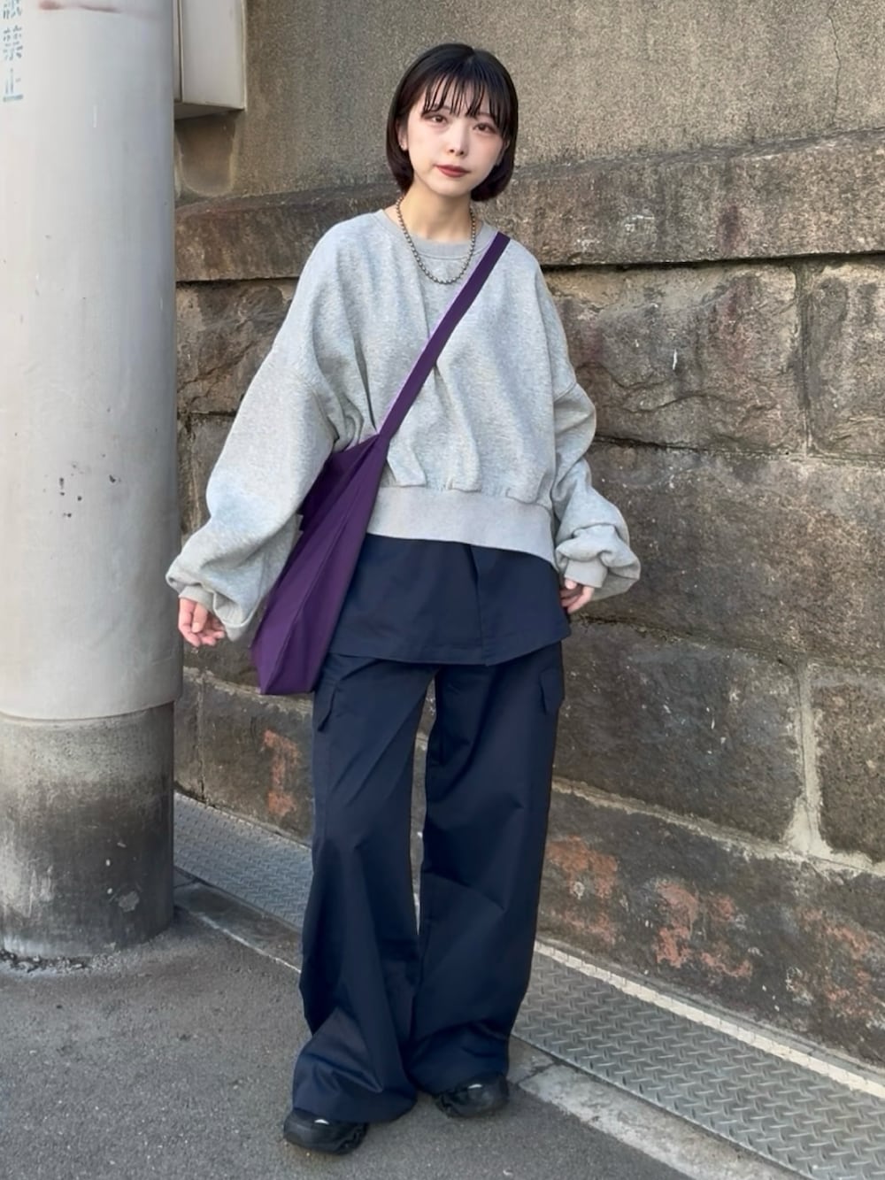 ブルー系のカーゴパンツ、グレー系のスウェット、レッド系のトートバッグを着用したレディースの春コーディネートの4枚目の写真
