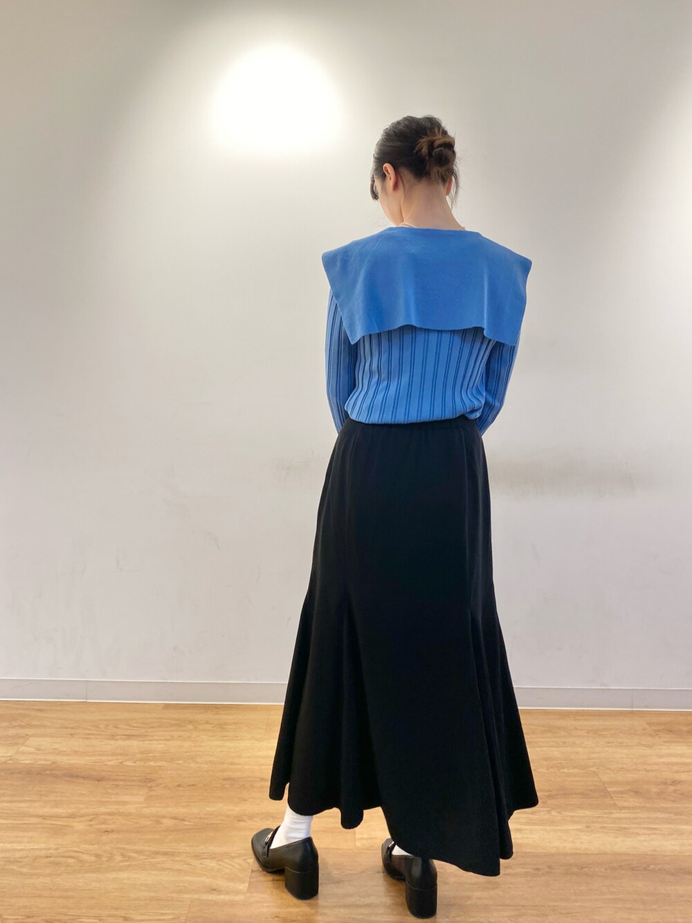 ブルー系のカーディガン/ボレロ、ブラック系のスカート、ブラック系のショルダーバッグを着用したレディースの春コーディネートの3枚目の写真