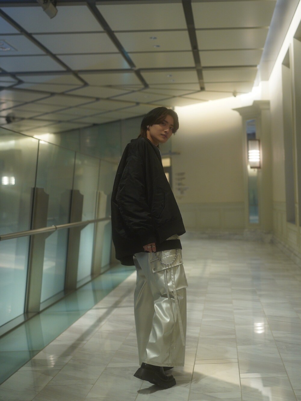 ブラック系のMA-1、ホワイト系のニット/セーター、シルバー系のカーゴパンツを着用したメンズの春コーディネートの5枚目の写真