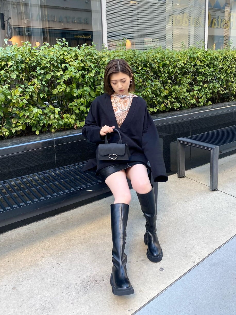 ブラック系のスカート、その他のTシャツ/カットソー、ブラック系のブーツを着用したレディースの冬コーディネートの5枚目の写真