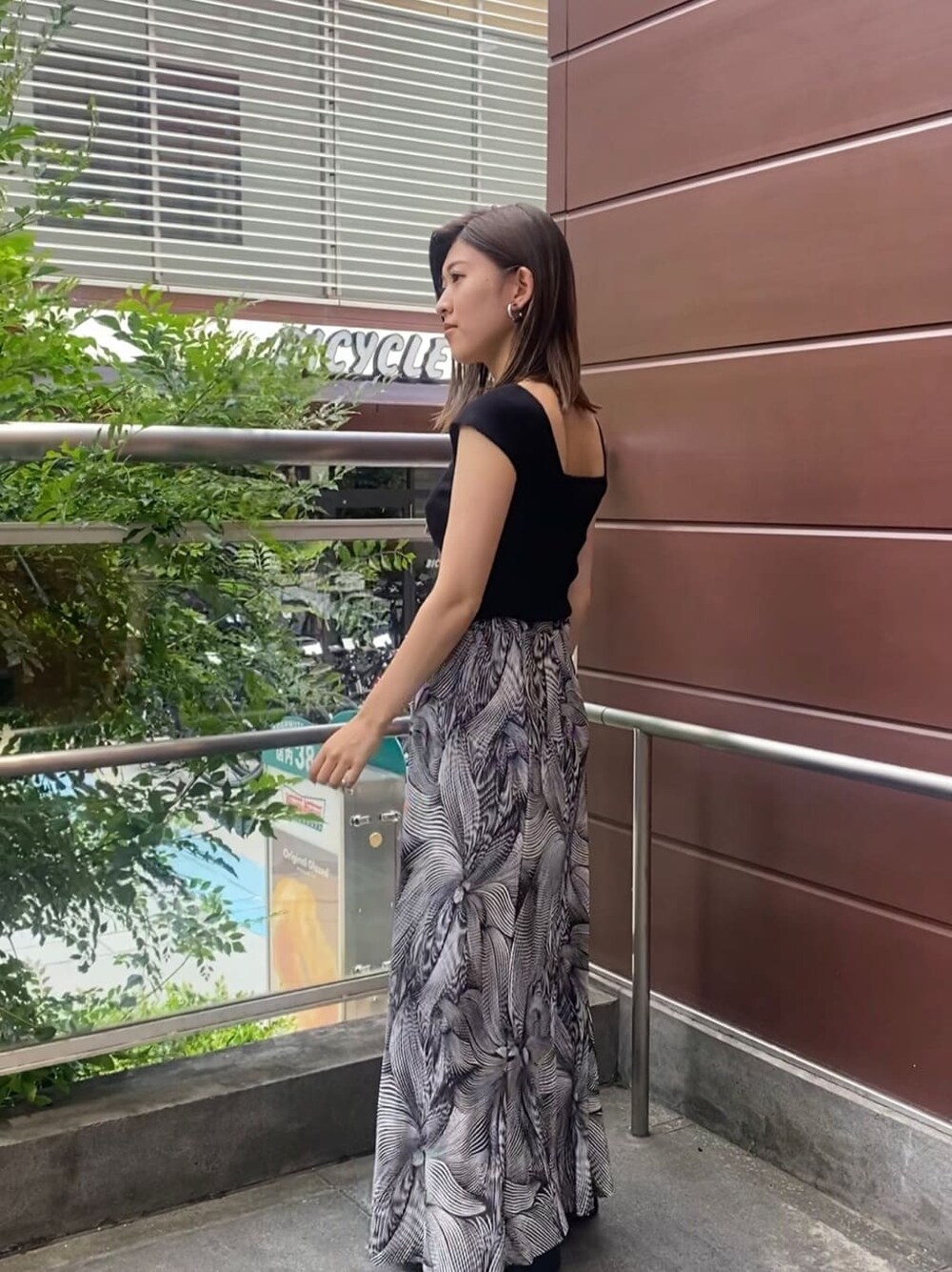 ブラック系のサンダル、ブラック系のタンクトップ、その他のスカートを着用したレディースの夏コーディネートの4枚目の写真