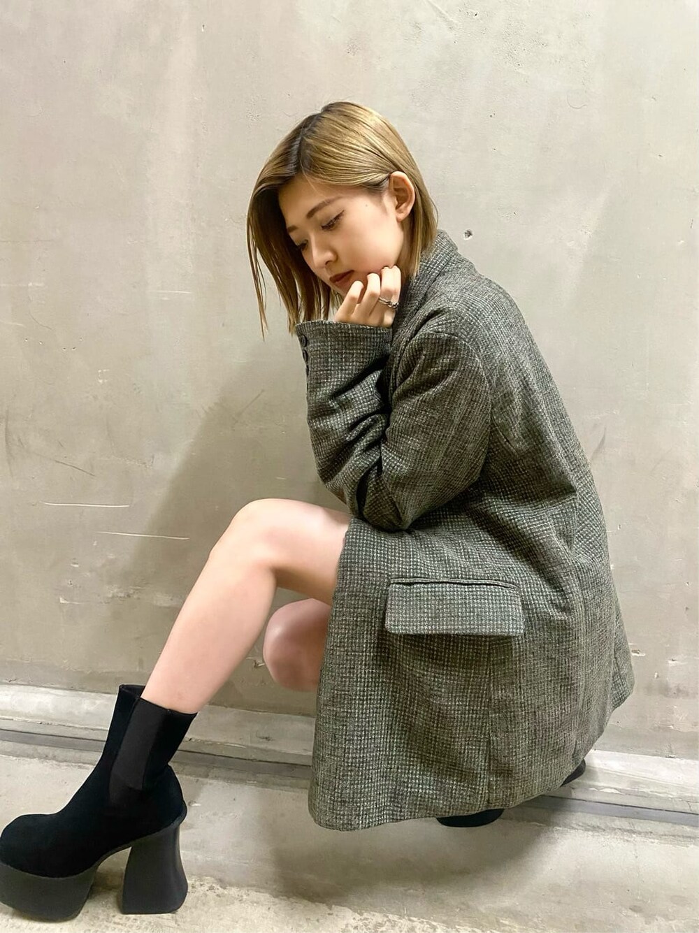 ベージュ系のテーラードジャケット、ベージュ系のスカート、ブラック系のブーツを着用したレディースの秋コーディネートの2枚目の写真