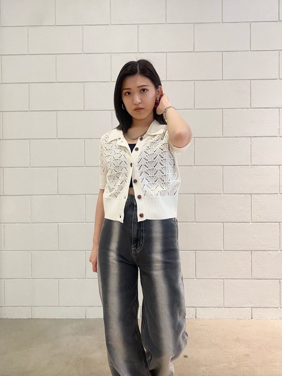 ブラック系のサンダル、ブラック系のデニムパンツ、ホワイト系のニット/セーターを着用したレディースの春コーディネートの6枚目の写真