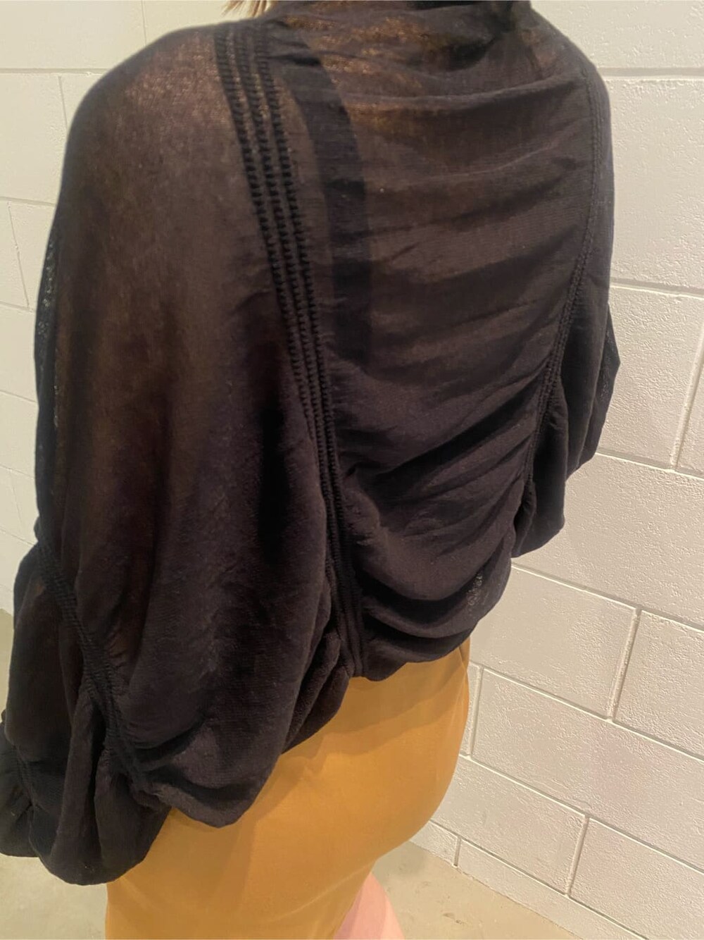 イエロー系のスカート、ブラック系のサンダル、ブラック系のカーディガン/ボレロを着用したレディースの夏コーディネートの6枚目の写真