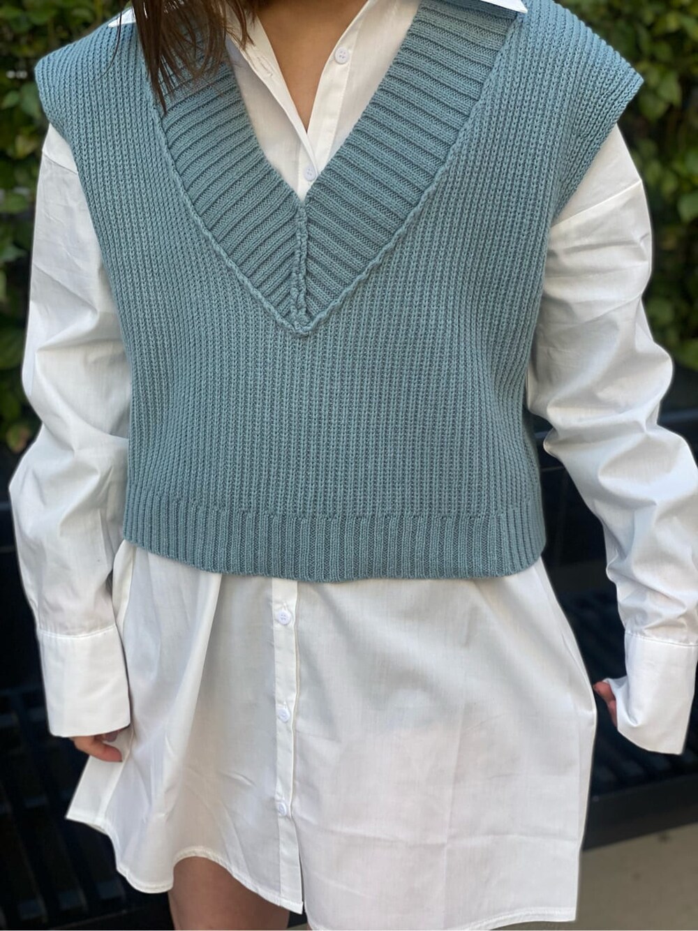 ホワイト系のシャツ/ブラウス、ブラック系のブーツ、ブルー系のベストを着用したレディースの春コーディネートの6枚目の写真