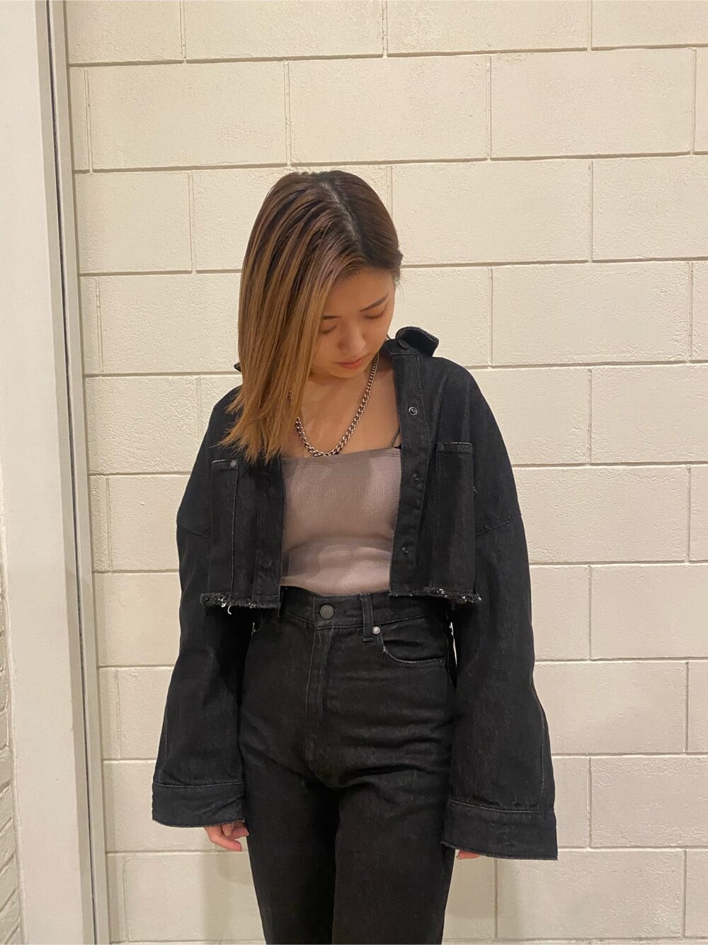 ホワイト系のローファー、グレー系のキャミソール、ブラック系のデニムジャケットを着用したレディースの春コーディネートの7枚目の写真