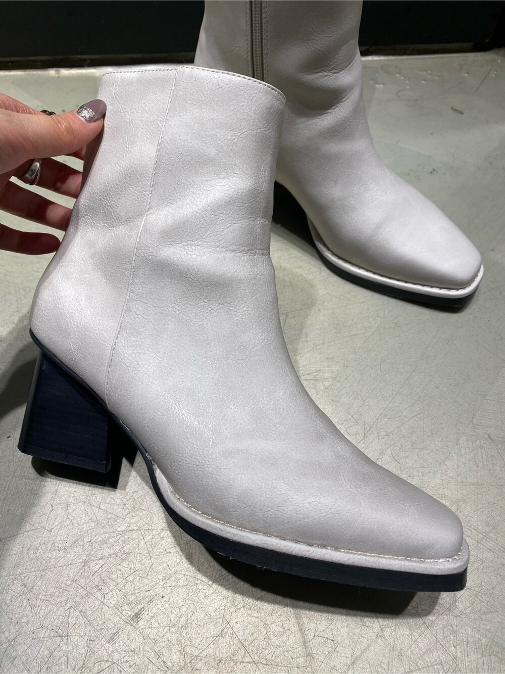 ブルー系のデニムパンツ、ホワイト系のブーツ、ホワイト系のニット/セーターを着用したレディースの冬コーディネートの4枚目の写真