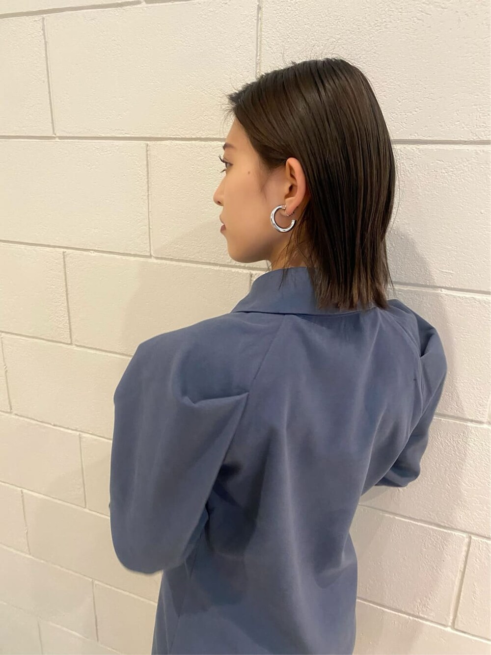 ブルー系のワンピース、ブラック系のブーツを着用したレディースの冬コーディネートの9枚目の写真