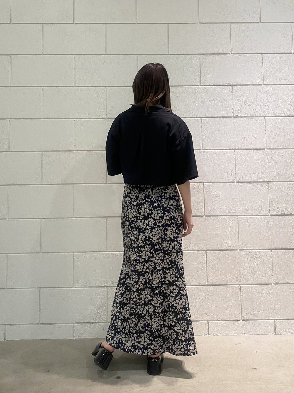 ブラック系のサンダル、ブラック系のシャツ/ブラウス、ホワイト系のTシャツ/カットソーを着用したレディースの春コーディネートの3枚目の写真