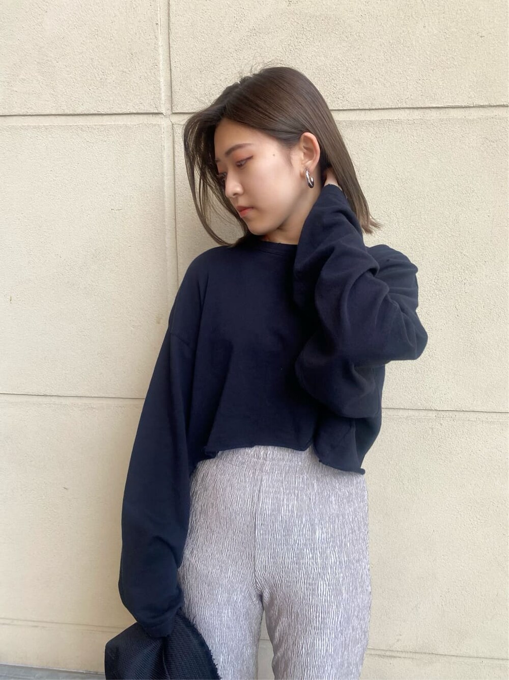 グレー系のその他パンツ、ブラック系のサンダル、ホワイト系のTシャツ/カットソーを着用したレディースの春コーディネートの6枚目の写真