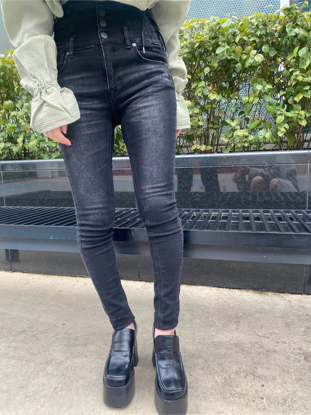 ブラック系のローファー、グリーン系のシャツ/ブラウス、ブラック系のデニムパンツを着用したレディースの冬コーディネートの7枚目の写真