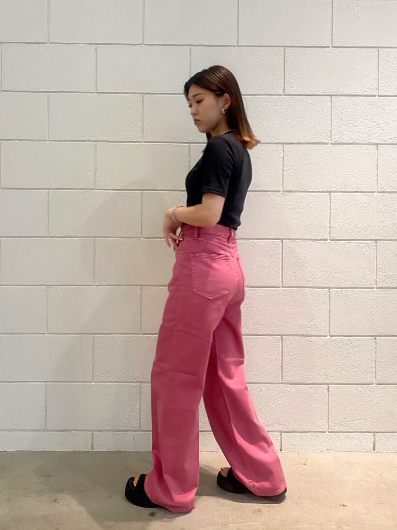 ピンク系のデニムパンツ、ブラック系のTシャツ/カットソー、シルバー系のネックレスを着用したレディースの夏コーディネートの3枚目の写真