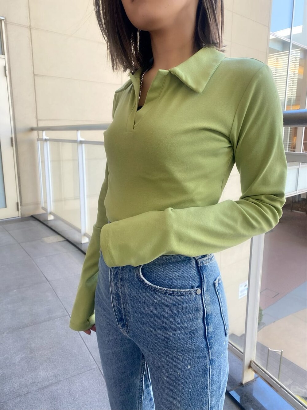 ブラック系のブーツ、ブルー系のデニムパンツ、イエロー系のTシャツ/カットソーを着用したレディースの冬コーディネートの7枚目の写真