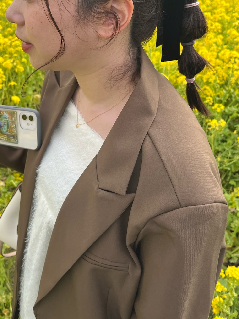 ホワイト系のシャツ/ブラウス、ブラウン系のテーラードジャケット、ピンク系のハンドバッグを着用したレディースの春コーディネートの2枚目の写真