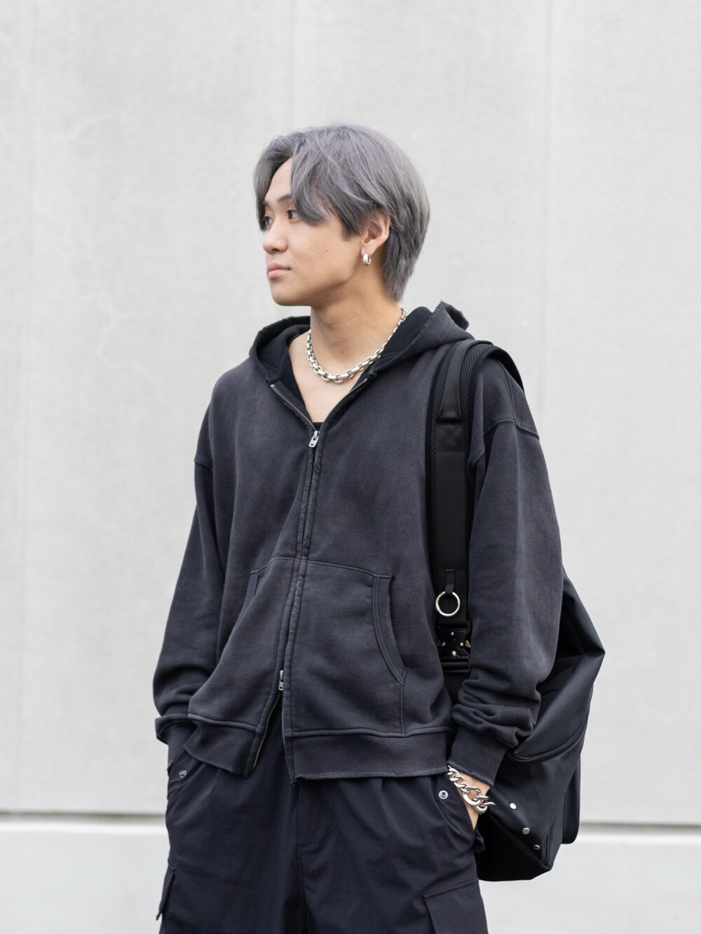 ブラック系のスニーカー、ブラック系のカーゴパンツ、ブラック系のボディバッグ/ウエストポーチを着用したメンズの秋コーディネートの4枚目の写真