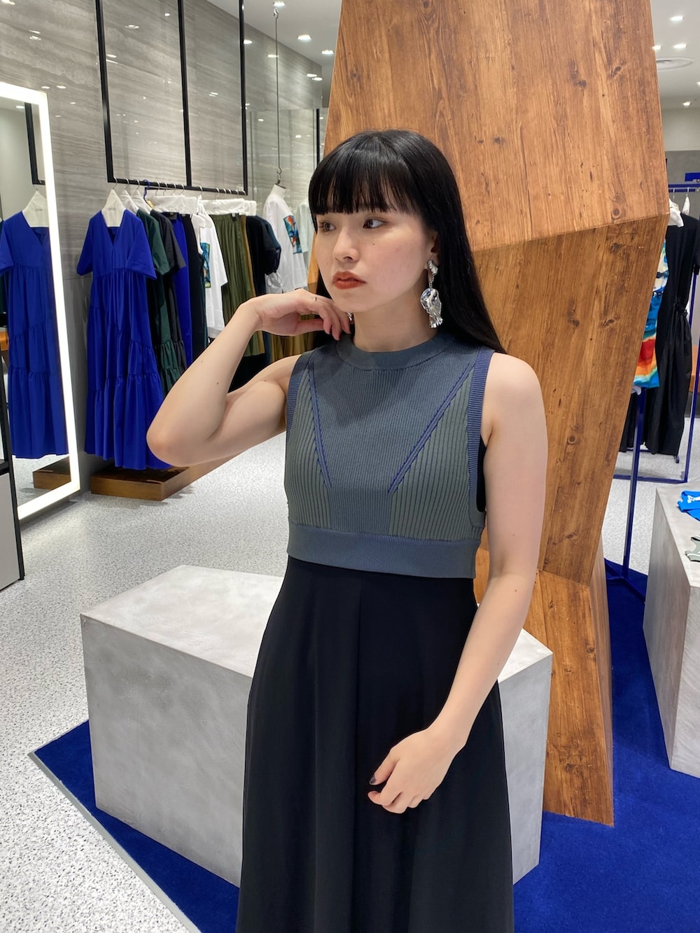 ブラック系のワンピース、グリーン系のタンクトップ、ブラック系のサンダルを着用したレディースの夏コーディネートの6枚目の写真