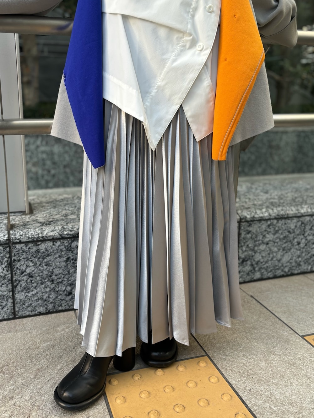 ホワイト系のシャツ/ブラウス、ベージュ系のニット/セーター、シルバー系のスカートを着用したレディースの冬コーディネートの7枚目の写真