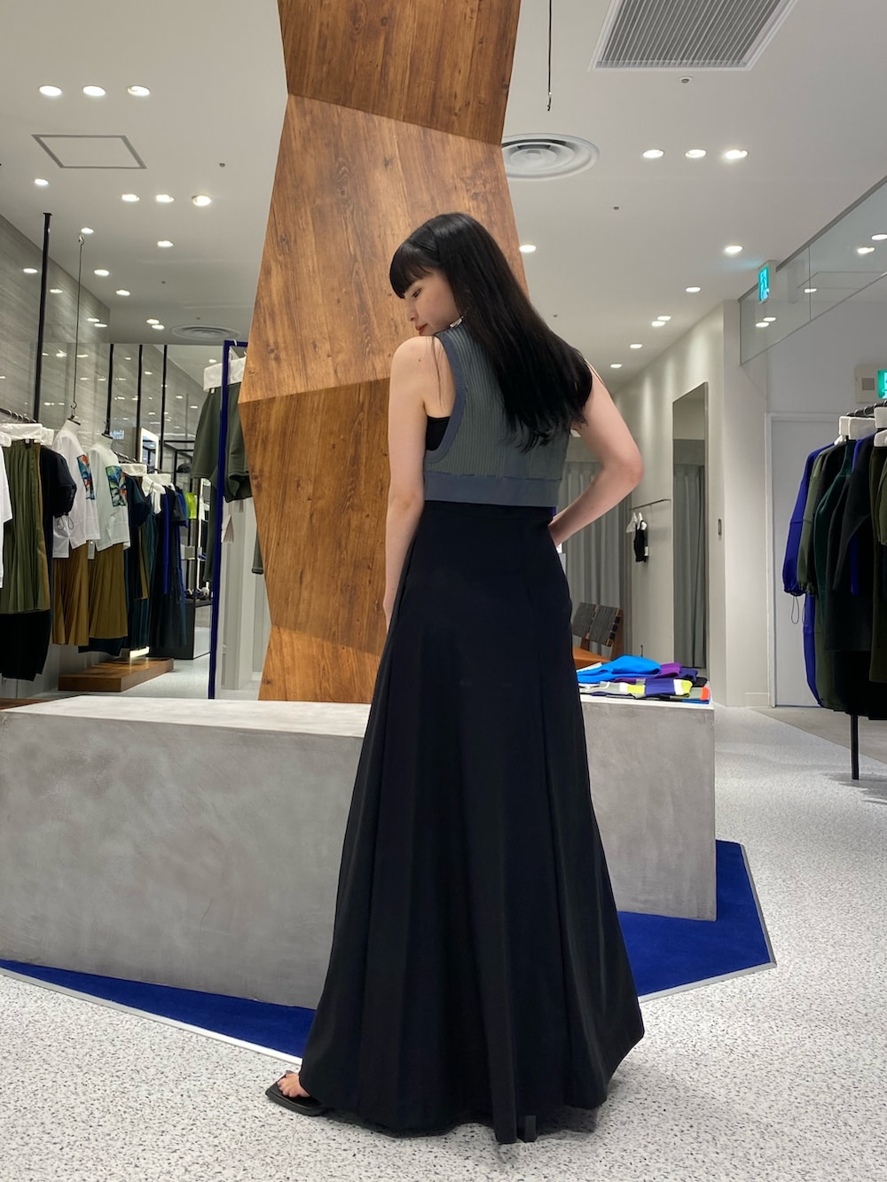 ブラック系のワンピース、グリーン系のタンクトップ、ブラック系のサンダルを着用したレディースの夏コーディネートの4枚目の写真