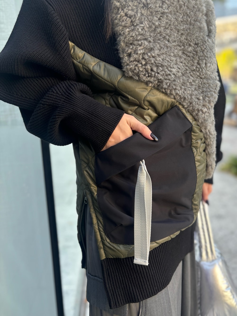 グレー系のその他パンツ、シルバー系のハンドバッグ、ブラック系のニット/セーターを着用したレディースの秋コーディネートの7枚目の写真