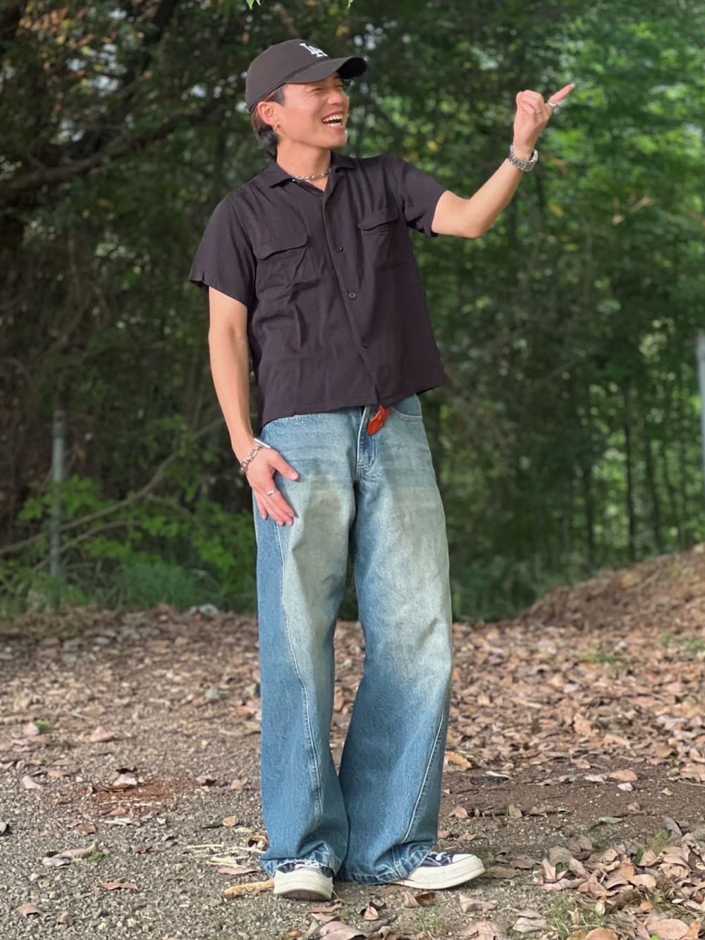 ブルー系のデニムパンツ、ブラック系のハンドバッグ、ブラック系のシャツ/ブラウスを着用したメンズの夏コーディネートの2枚目の写真