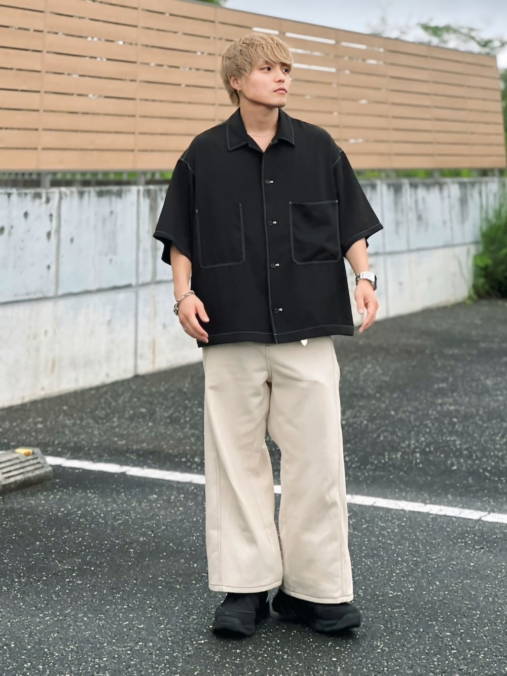 ブラック系のスニーカー、ホワイト系のタンクトップ、ホワイト系のデニムパンツを着用したメンズの夏コーディネートの3枚目の写真