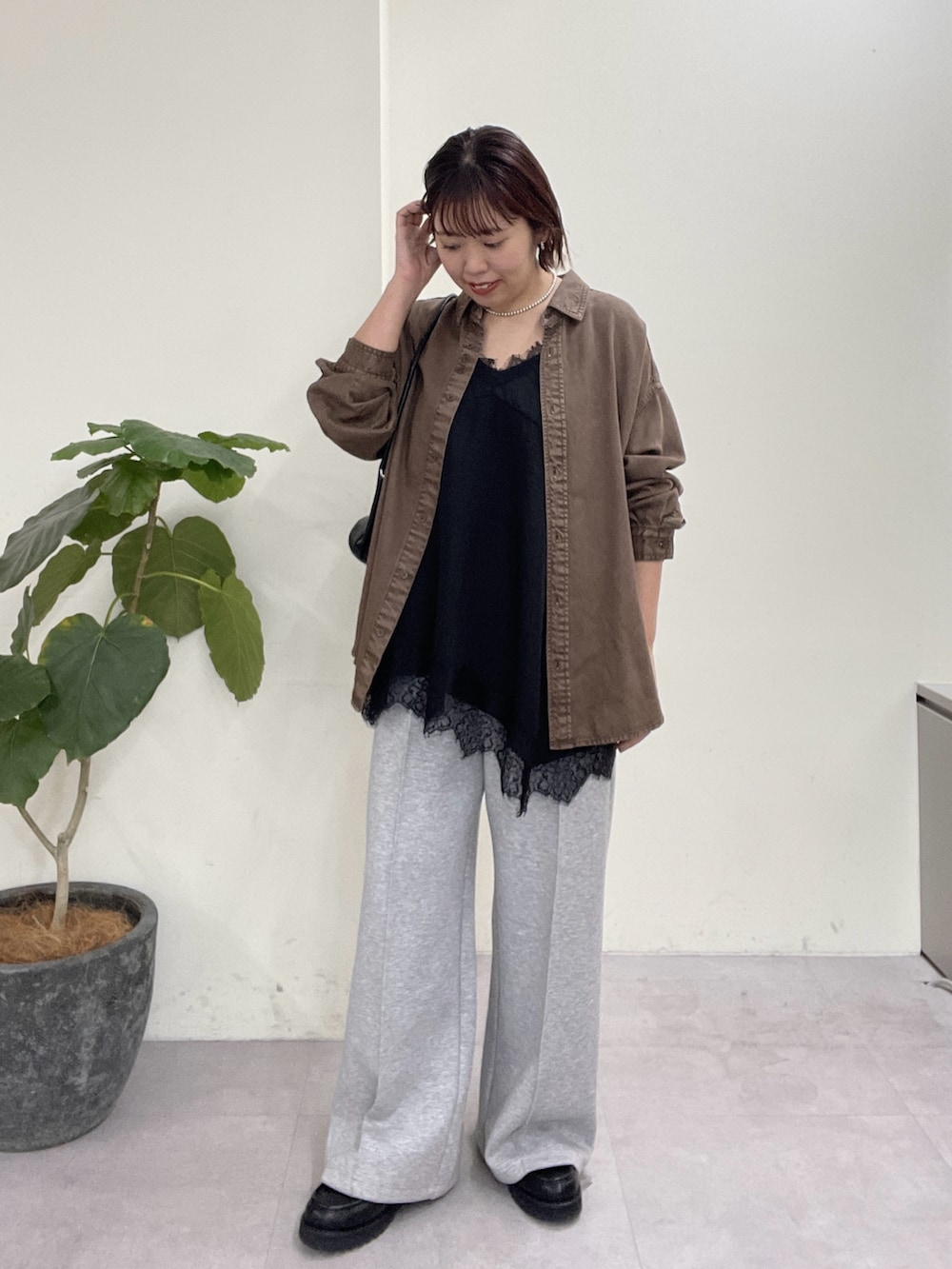 ブラウン系のシャツ/ブラウス、ブラック系のキャミソール、グレー系のその他パンツを着用したレディースの春コーディネートの2枚目の写真