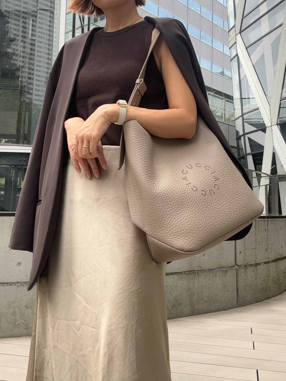 ブラウン系のショルダーバッグを着用したレディースの夏コーディネートの2枚目の写真