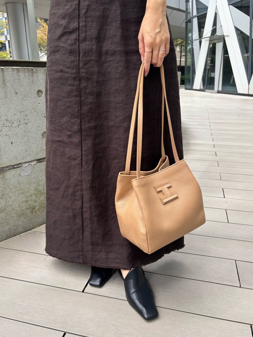 イエロー系のトートバッグを着用したレディースの秋コーディネートの3枚目の写真