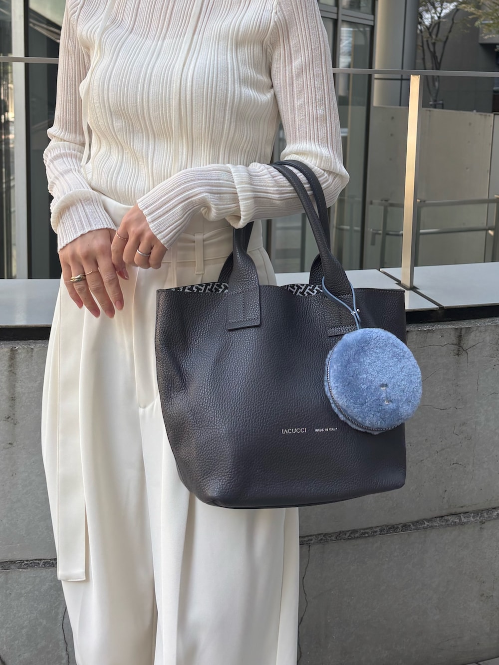 グレー系のトートバッグ、ブルー系のその他小物を着用したレディースの秋コーディネートの3枚目の写真