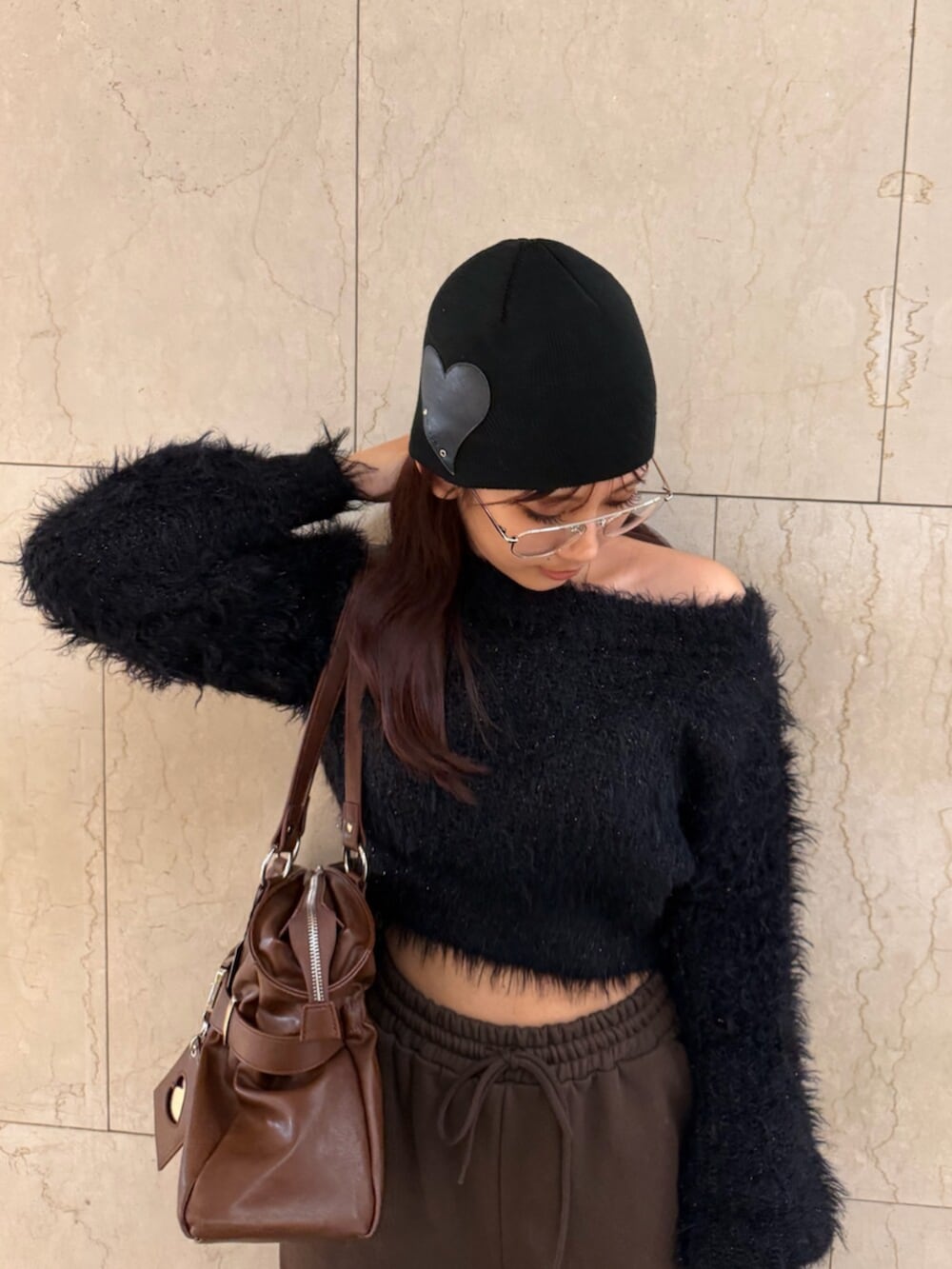 ブラック系のブーツ、ブラウン系のトートバッグ、ブラック系のニット/セーターを着用したレディースの冬コーディネートの4枚目の写真