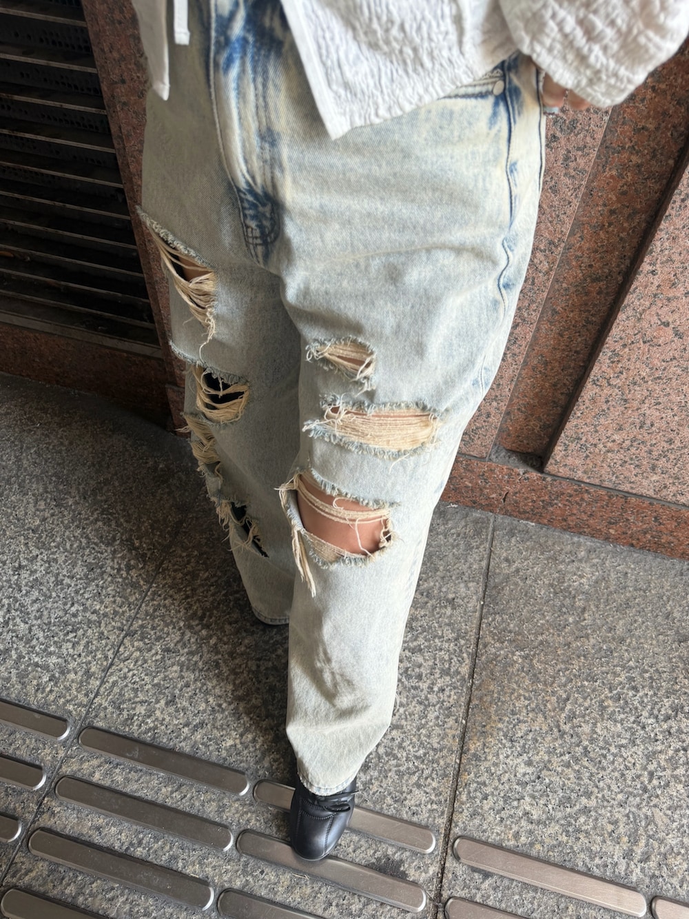 ホワイト系のTシャツ/カットソー、ブルー系のデニムパンツ、ホワイト系のショルダーバッグを着用したレディースの春コーディネートの7枚目の写真