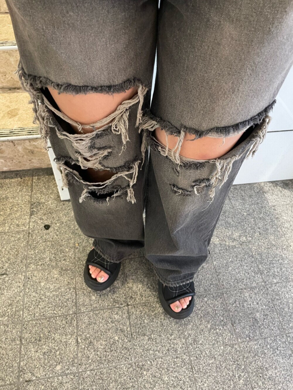 ブラック系のサンダル、ホワイト系のハンドバッグ、ブラック系のTシャツ/カットソーを着用したレディースの夏コーディネートの10枚目の写真