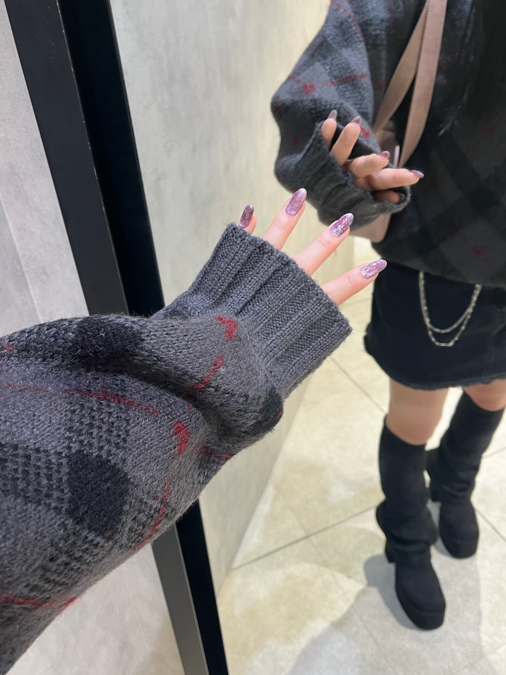 ブラック系のスカート、ピンク系のハンドバッグ、グレー系のニット/セーターを着用したレディースの秋コーディネートの10枚目の写真