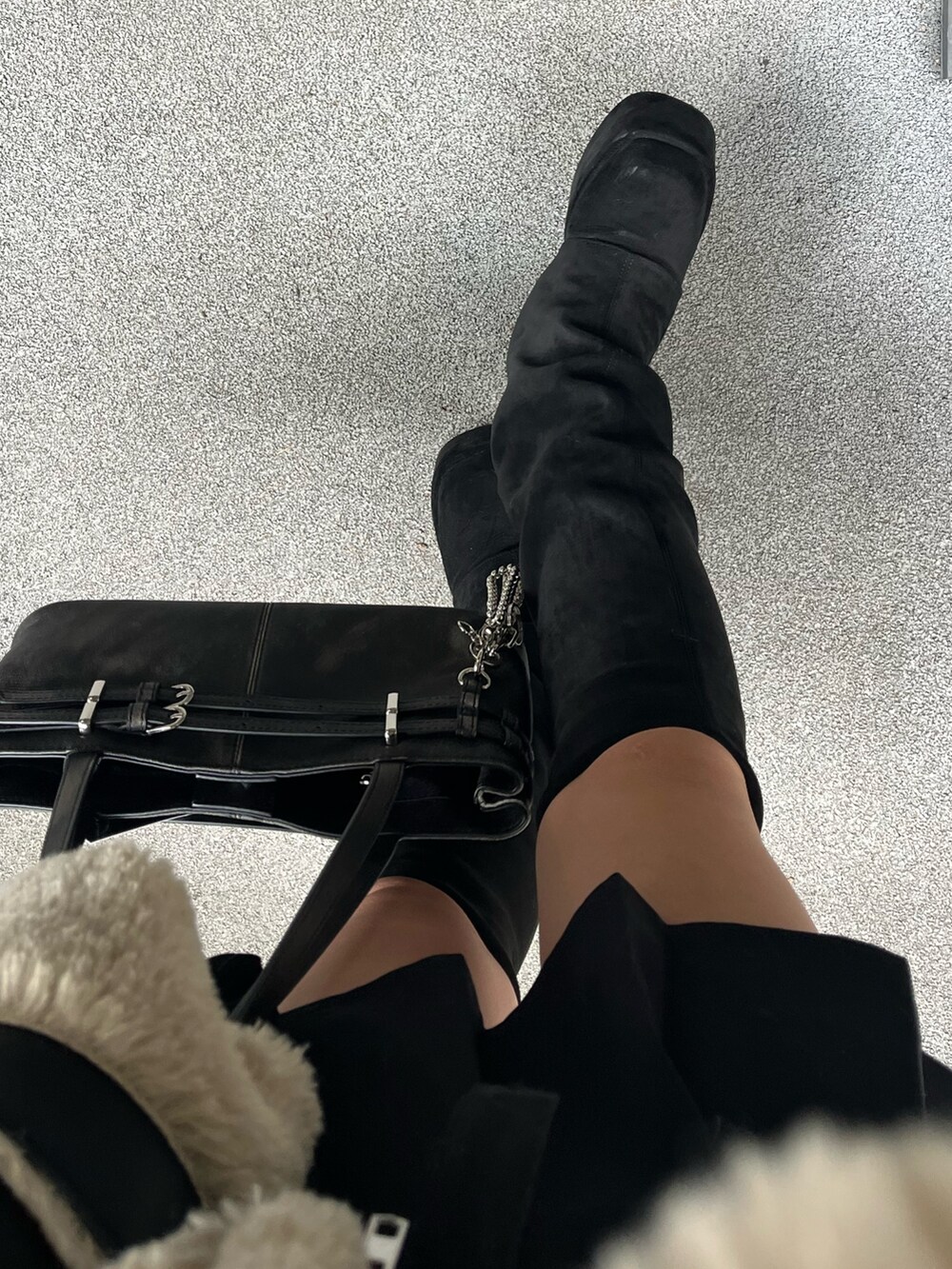 ブラック系のショルダーバッグ、ブラック系のブーツ、ブラック系のスカートを着用したレディースの秋コーディネートの10枚目の写真