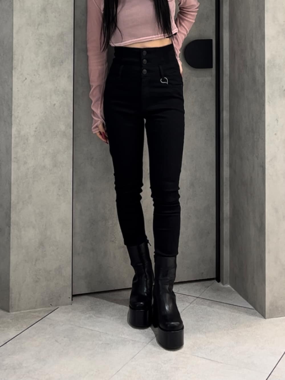 ピンク系のTシャツ/カットソー、ブラック系のデニムパンツ、ブラック系のブーツを着用したレディースの冬コーディネートの8枚目の写真