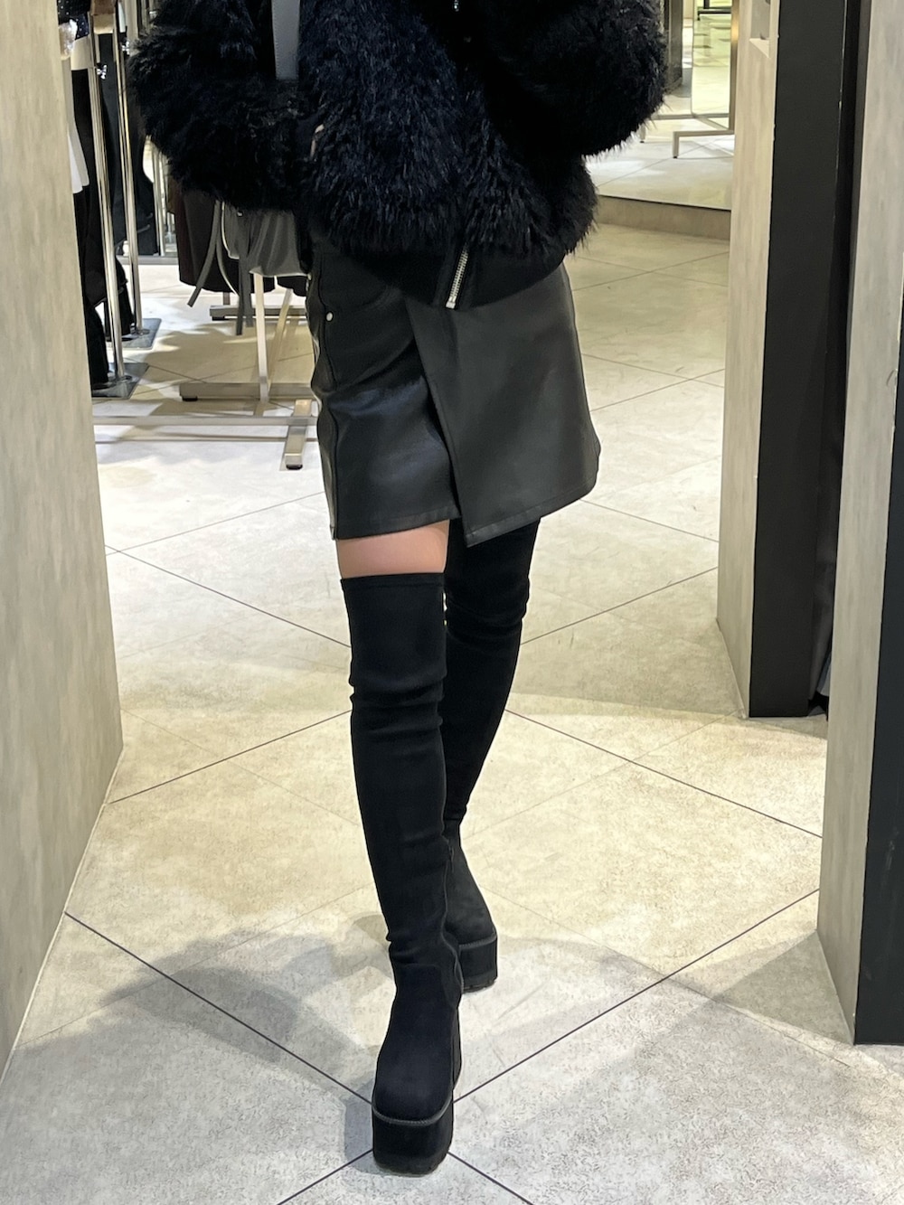 ブラック系のブーツ、グレー系のハンドバッグ、ブラック系のスカートを着用したレディースの秋コーディネートの9枚目の写真