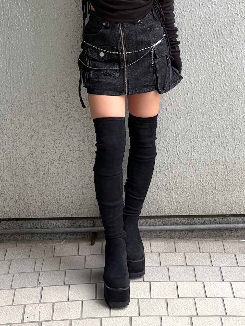 ブラック系のTシャツ/カットソー、ブラック系のスカート、ブラック系のブーツを着用したレディースの秋コーディネートの9枚目の写真