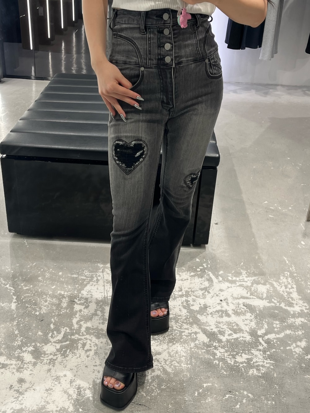 ホワイト系のニット/セーター、ブラック系のデニムパンツ、ブラック系のサンダルを着用したレディースの春コーディネートの7枚目の写真