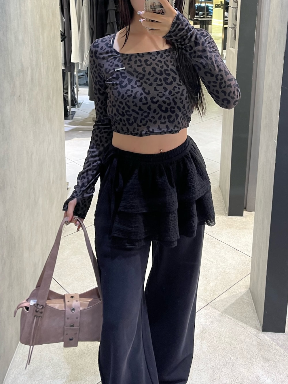 ブラック系のスカート、ブラック系のスウェットパンツ、ピンク系のハンドバッグを着用したレディースの秋コーディネートの5枚目の写真