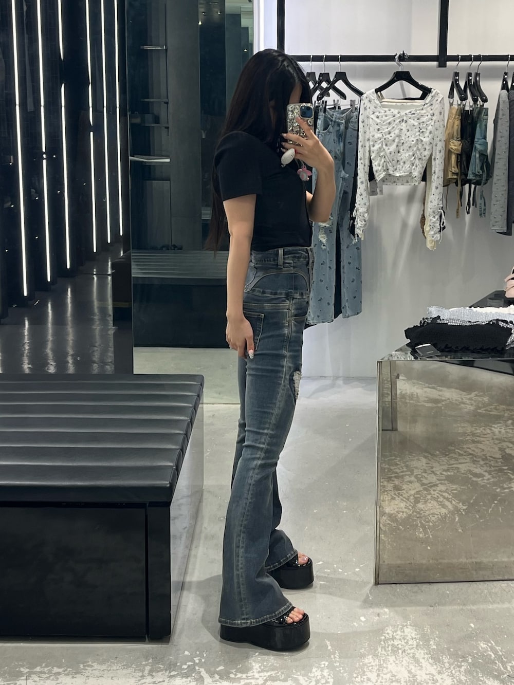 ブラック系のTシャツ/カットソー、ブルー系のデニムパンツ、ブラック系のサンダルを着用したレディースの春コーディネートの2枚目の写真
