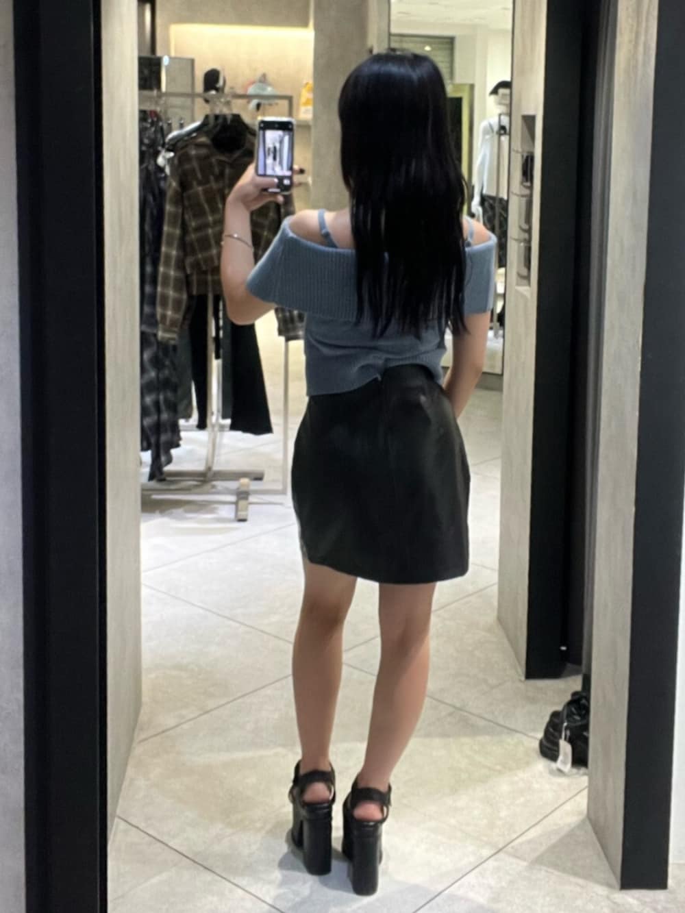 ブラック系のサンダル、ブルー系のニット/セーター、ブラック系のスカートを着用したレディースの秋コーディネートの3枚目の写真