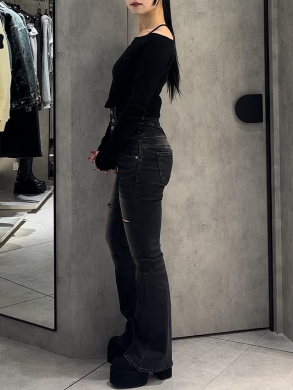 ブラック系のTシャツ/カットソー、ブラック系のデニムパンツ、ブラック系のブーツを着用したレディースの冬コーディネートの3枚目の写真