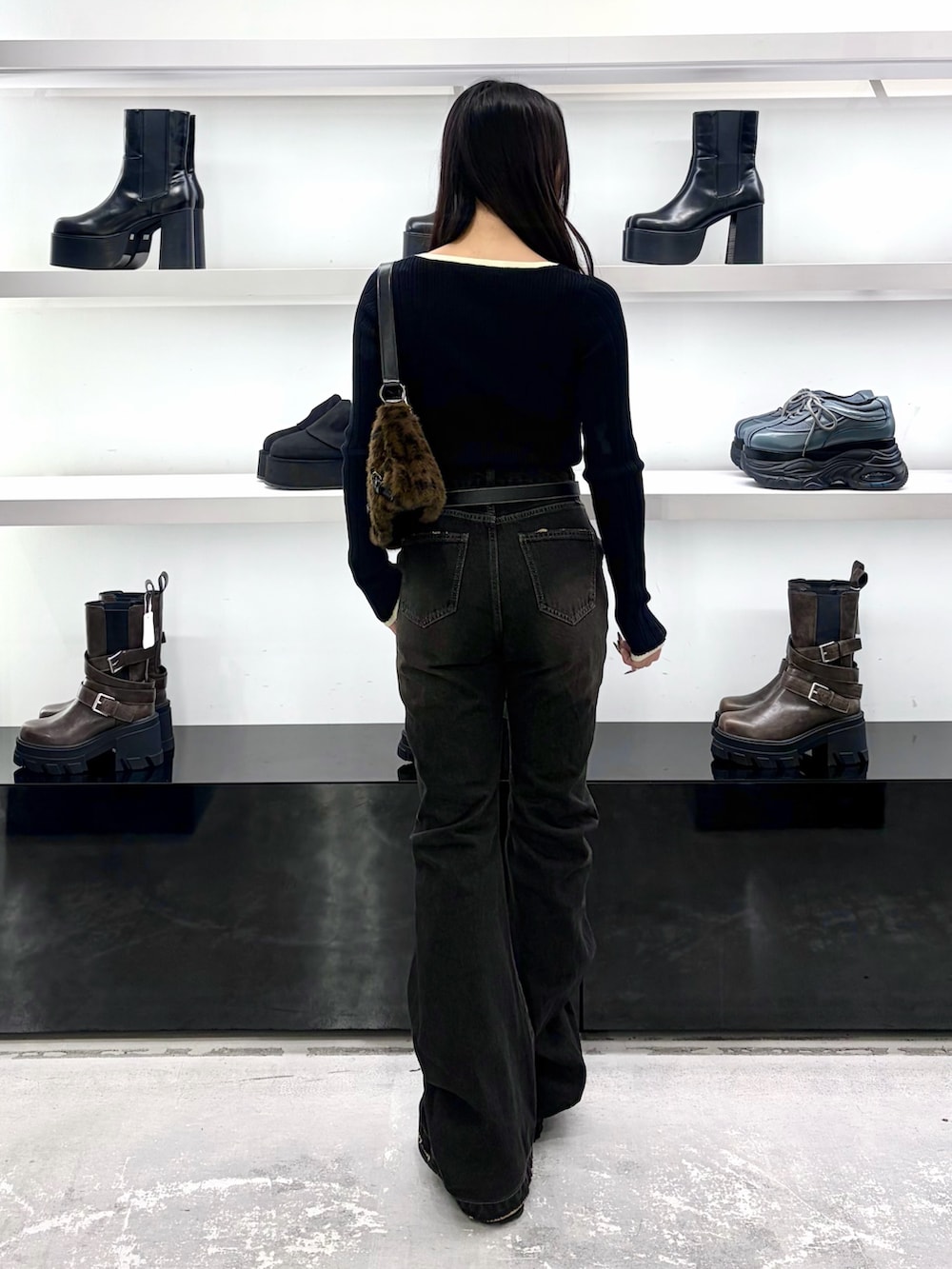 ブラック系のニット/セーター、その他のショルダーバッグ、ブラック系のデニムパンツを着用したレディースの秋コーディネートの4枚目の写真