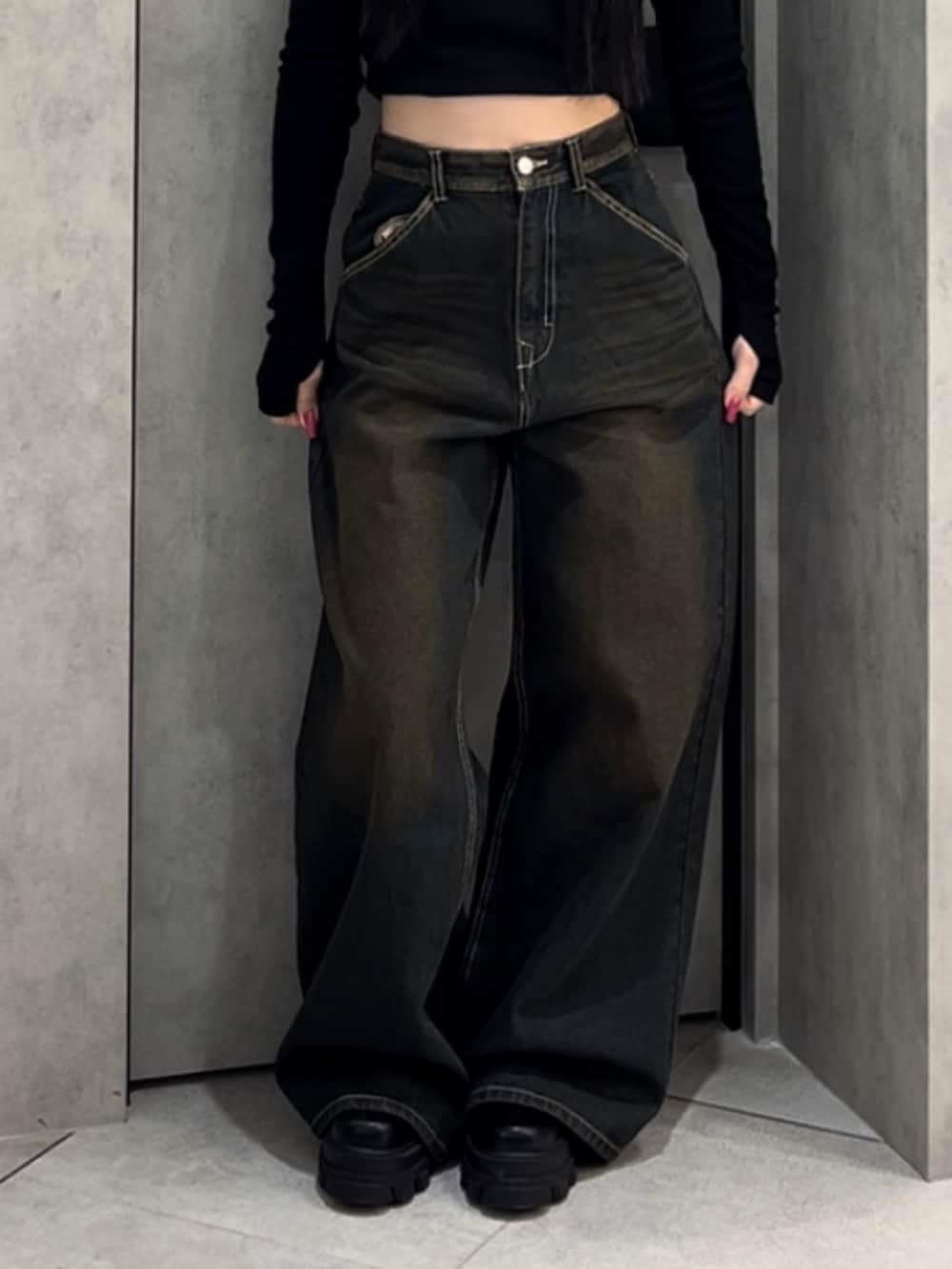 ブラック系のTシャツ/カットソー、ブルー系のデニムパンツ、ブラック系のブーツを着用したレディースの冬コーディネートの9枚目の写真