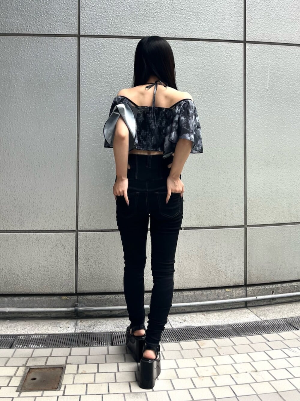 ブラック系のサンダル、ブラック系のデニムパンツを着用したレディースの夏コーディネートの5枚目の写真